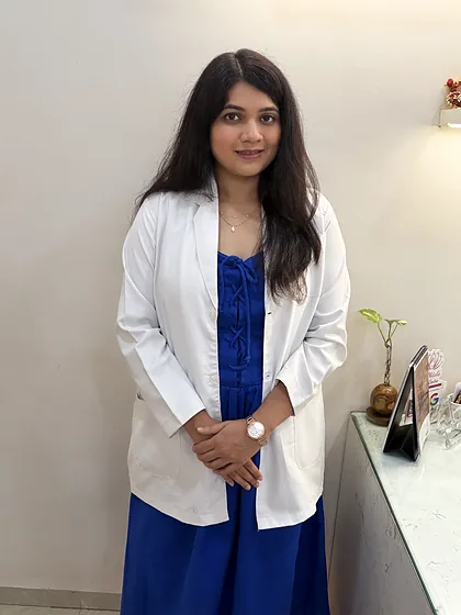 Dr Mitali Pardhi standing in her clinic in a white coat